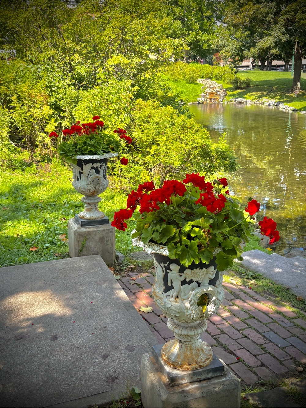 Classic White Ornate Urn Planter with Red Blossoms